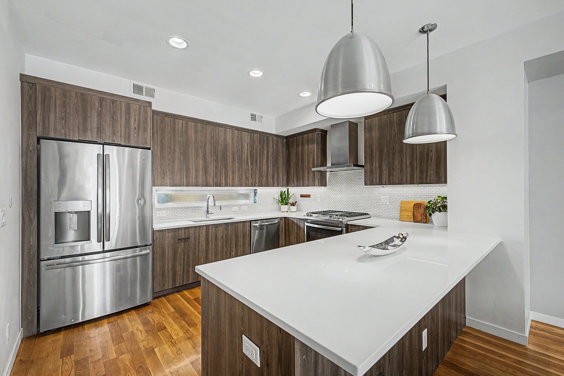 Contemporary kitchen with expansive island and wood cabinetry